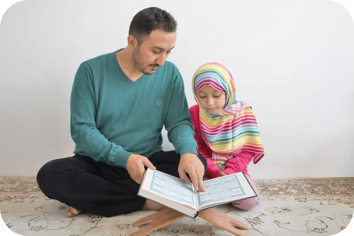 A Muslim father teaching his daughter Quran reading
