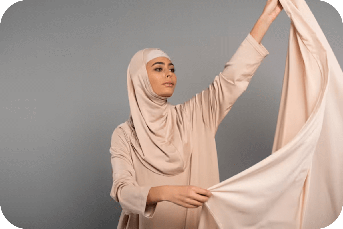 A Muslim woman in Pink silk hijab and abaya