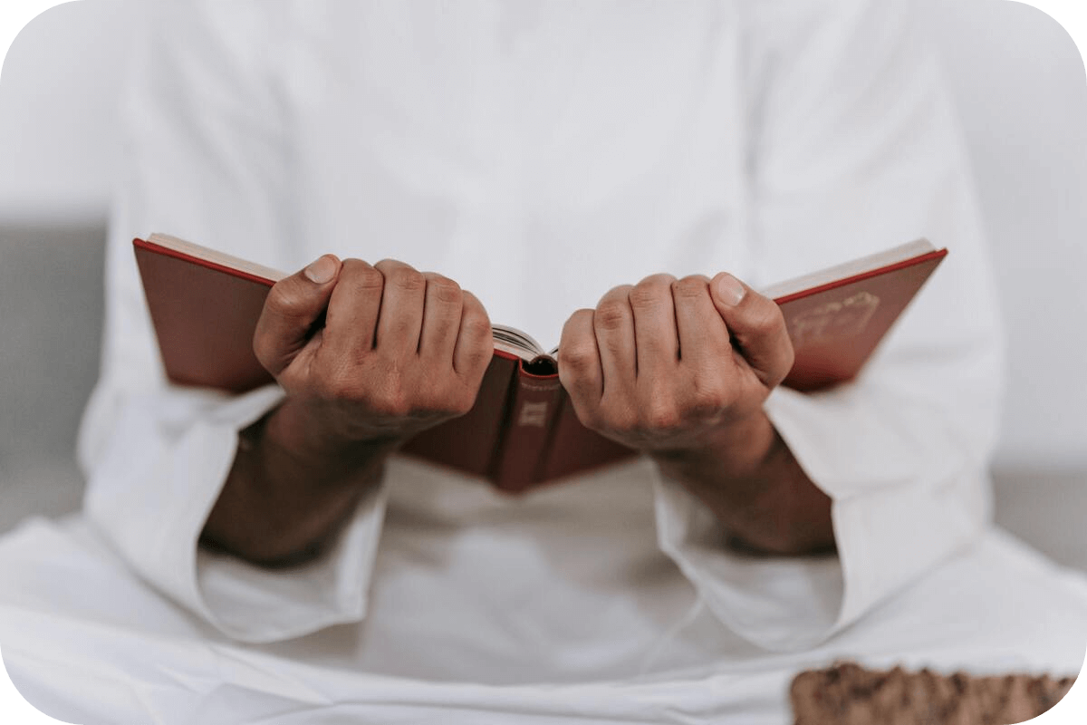 A Muslim man holding the Quran in his hands