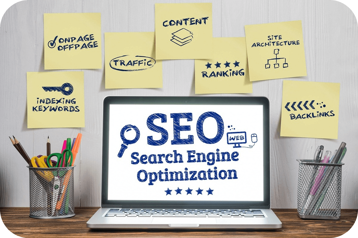 A Laptop screen displaying tag 'search engine optimisation' along with sticky notes around it on the wall