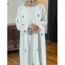 Perfect Gift * MADE TO ORDER * PLEASE ALLOW 3-4 WEEKS FOR ALL BRIDAL ORDERS.   EDITOR'S NOTE New show-stopping design. High quality flowing white dress, carefully hand embellished with stunning clear and bronze crystal detailing. Guaranteed to turn heads at weddings or special events. Luxury at its finest. Matching scarf is included.&nbsp; Made in the UAE.&nbsp;  SIZE/FIT Model wears: Abaya size 58 Model's height: 5ft 5inches/165 cm (w/o heels)  PRODUCT DETAILS/CARE Wash care: Hand wash 30oC, Do not tumble dry and low heat iron.    PLEASE NOTE SOME OF THE COLOURS MAY VARY SLIGHTLY IN REAL DUE TO THE LIGHTING AND BRIGHTNESS ON COMPUTER SCREENS