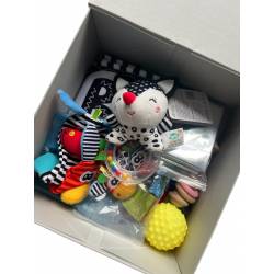 Perfect Gift Unlock the wonders of early development with our Personalised Baby Sensory Box, thoughtfully designed to engage your little one's senses and stimulate their curiosity. Packed with high-quality, safe, and thoughtful items, this sensory box provides endless opportunities for play, exploration, and bonding. Each item is carefully selected to nurture your baby's motor skills, sensory perception, and cognitive development. Included in the box:  Personalised Touch: Each box is uniquely personalised with your baby’s name, adding a special, heartfelt touch. Rattle: A soft, gentle rattle that encourages auditory exploration while promoting hand-eye coordination. Wooden Rattle: A durable, natural wooden rattle with smooth edges, perfect for little hands to grasp and shake. Nylon Scarf: Colorful, lightweight scarf that introduces your baby to vibrant colors, textures, and gentle movement. Squeeze Toy: A soft, squeezable toy designed to help strengthen tiny hands while delighting with fun sounds and textures. Fabric Book: A sensory-rich fabric book filled with contrasting patterns, textures, and images that are ideal for visual and tactile exploration. Foil Sheet: A crinkly, shiny foil sheet that offers satisfying sensory feedback, perfect for developing tactile awareness. Hand and Feet Rattles: Soft and lightweight rattles that can be easily attached to your baby’s hands and feet, encouraging movement and helping develop motor skills. Rainbow Ribbon: A vibrant rainbow ribbon that stimulates visual tracking and hand-eye coordination as babies reach, grasp, and play.  Ideal for babies from newborn to six months and beyond, this sensory box provides the perfect mix of auditory, tactile, and visual stimulation, helping your little one reach important developmental milestones in a fun and interactive way.&nbsp;