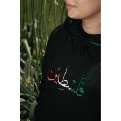 Perfect Gift The "Falusteen" design is one of the most beloved and classic ways to represent Palestine, beautifully rendered in Arabic with the vibrant colours of the Palestinian flag&mdash;green, red, black, and white. This timeless design makes a bold statement of pride and unity, perfect for anyone looking to wear their heritage with love and strength. A simple yet powerful way to carry the spirit of Palestine wherever you go.