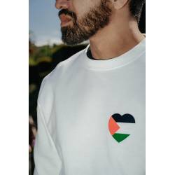 Perfect Gift This sweatshirt carries a powerful message of love, unity, and support for the Palestinian people and their homeland. The heart, thoughtfully designed in the iconic Palestine flag colours&mdash;green, red, and black&mdash;represents not only solidarity but also the deep compassion and kindness we extend to one another through difficult times. Made from soft, durable white fabric, this piece combines both comfort and purpose. The vinyl design in bold colours brings a strong yet subtle statement&mdash;perfect for those who wear their values proudly. A beautiful way to show support, honour a homeland, and stand in solidarity with Palestine, all while wearing something comfortable and meaningful.
