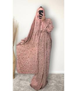 Perfect Gift  One Size Only (52" - 64") fits UK sizes 8 to 24.  62-64”/160cm- Standard Length: The dress is designed to be long enough to cover your feet while praying Salah. If you would like to adjust the length, please click on the 'Tailored Length' option and specify your preferred length in the 'Order Notes' section at checkout, or email us, and we will confirm the change via email. You can refer to the size chart below to help you determine the suitable length  83cm - Width of dress : This refers to one side of the dress when laid flat, making the full circumference approximately 166cm. The dress is intentionally designed to be wide and oversized for a modest, full-coverage fit.  75cm - Sleeve length (from wrist to shoulder) Hijab Measurements: 210 cm (Length) x 60 cm (Width) Optional: You can choose to have the hijab attached or separate from the abaya Attached Hijab: The hijab will be attached with the short side on the right allowing the long side to be wrapped with your left hand.&nbsp; If you prefer a right - handed wrapping arrangement, please add a note in the 'Order notes' section at checkout, or email us, and we will confirm the change via email. You must notify me within 24 hours before I proceed with sewing the custom attachment. Invisible side pockets Shirred cuff finished - Elasticated, gathered cuff with stitched rows that create a soft ruffle at the wrist.&nbsp; Material - Polyester&nbsp; Colour - Dusty rose pink  &nbsp;