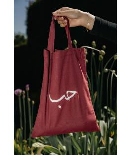 Perfect Gift Carry meaning wherever you go with our Hub Tote Bag in Red. Featuring the profound word hub meaning love, this cotton tote refers to a deep and abiding affection in the Arabic literature. Spacious, durable and designed for everyday use, it is perfect for errands, gifting or adding a faith inspired touch to your outfit. The vibrant red fabric paired with elegant embroidery makes this a standout piece in any collection.